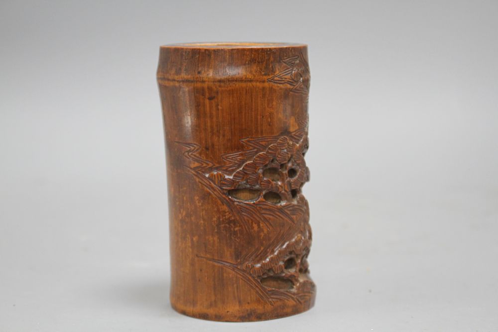 A Chinese bamboo brush pot, carved with scholars playing weiqi, late 19th/early 20th century H. 11.7cm